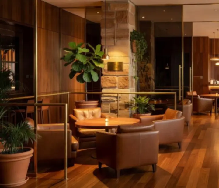 Cinematic interior of RiversideDealTable with warm lighting, sandstone and Australian hardwood finishes